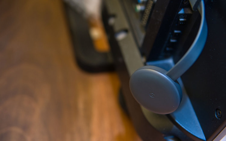 Google Chromecast device is plugged into a port on the back of TV