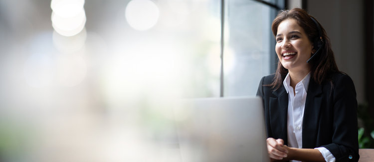 a woman wearing headsets and smiling - customer service