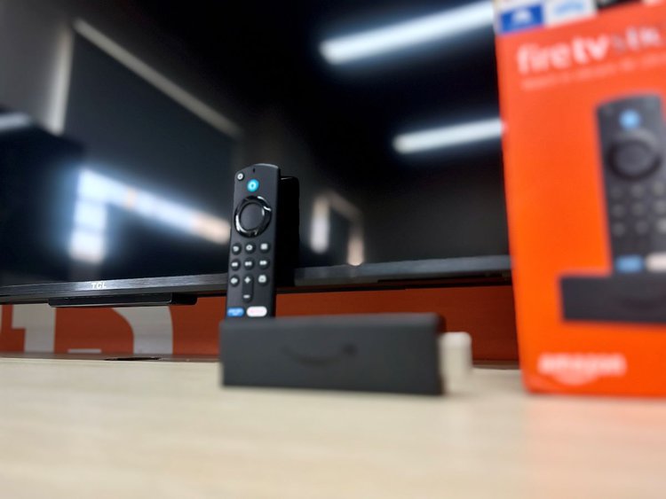 fire tv stick in front of a tcl tv