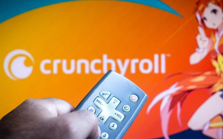 one is holding the TV remote control to watch anime on Crunchyroll