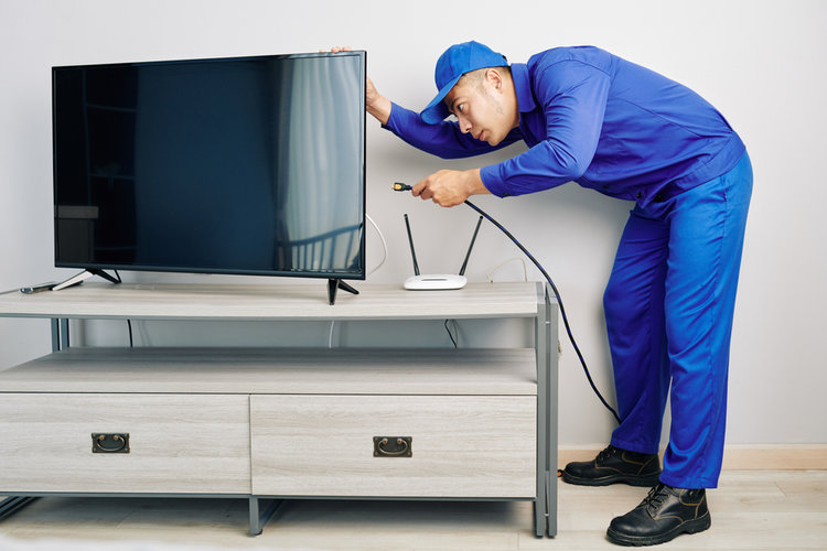 A man checking cable on TV
