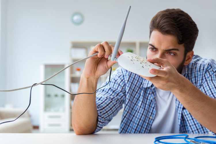 A man checking his wifi router