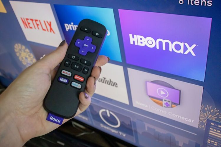 Roku remote in front of a TV