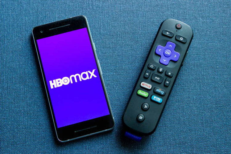 Roku voice remote and a phone with HBO Max app
