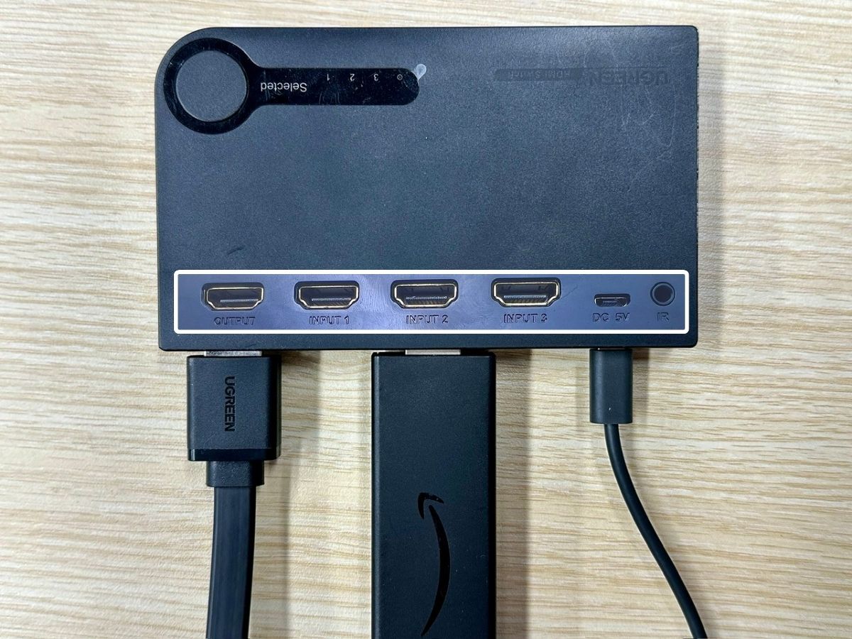 a fire tv stick and an hdmi to vga adapter are plugged into an hdmi switch