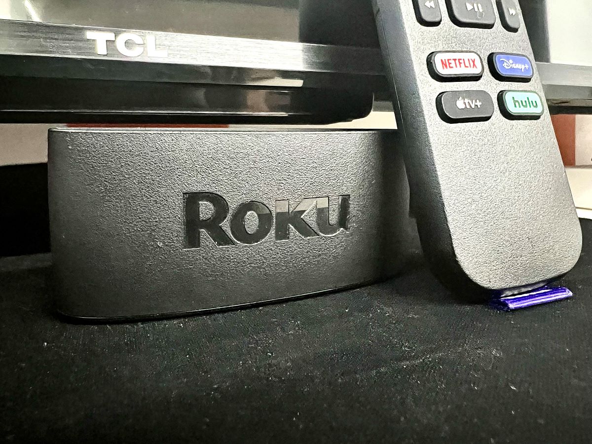 a roku in front of a tcl tv