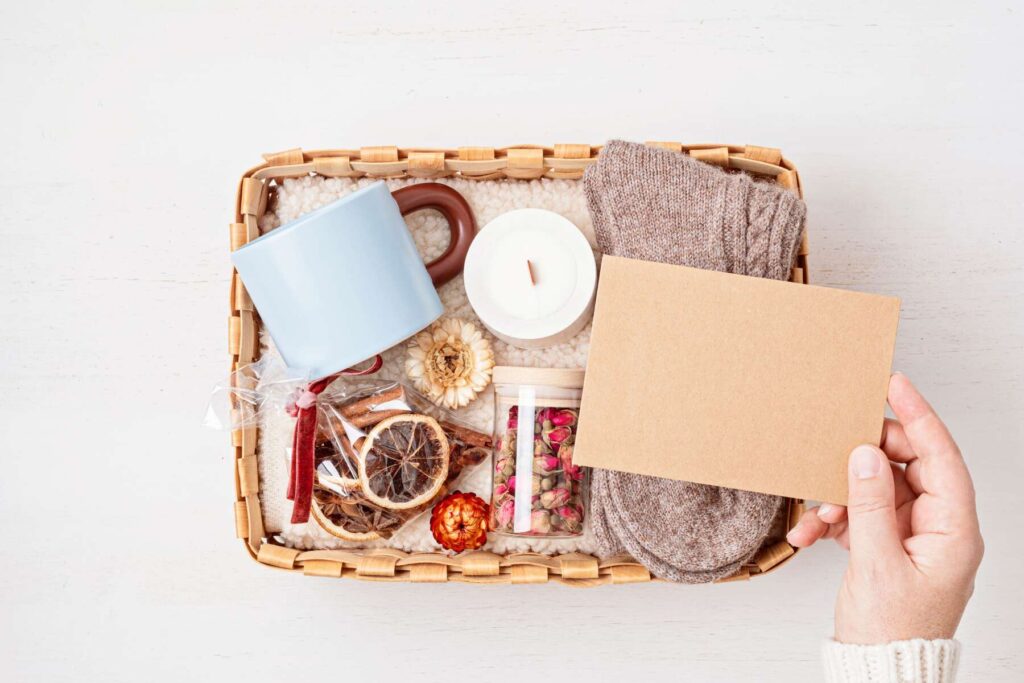 care package with warm socks, tea mug, aroma spices and candle