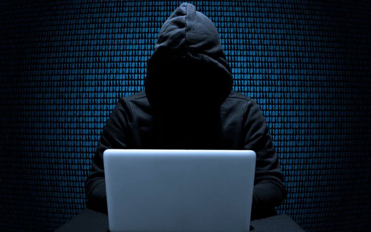 hacker uses a laptop
