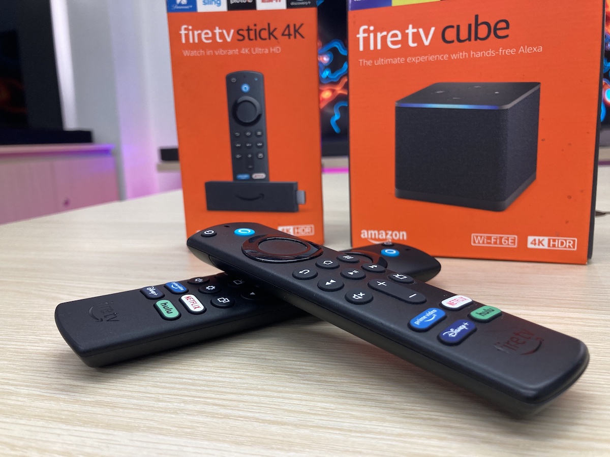 two fire tv stick remotes with their boxes on a table