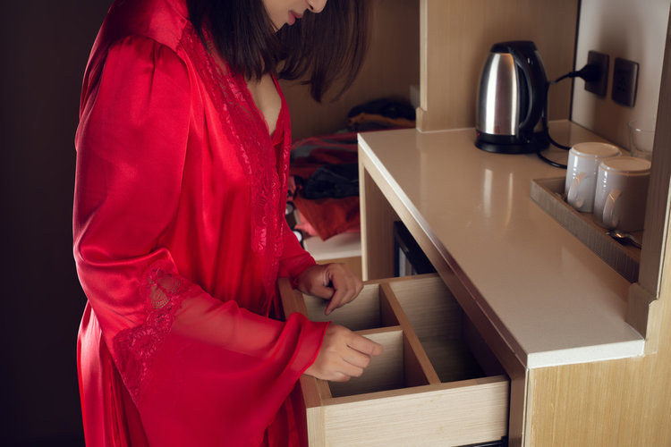 A woman searching for something inside the draw