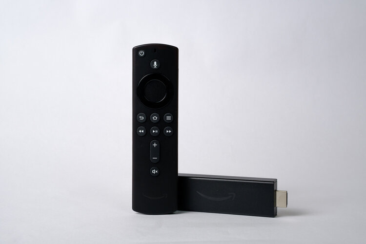 Amazon Fire Stick and remote in white background