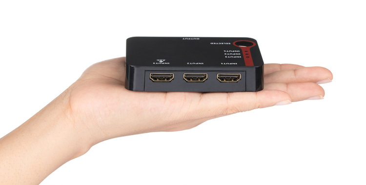 hand holding a black HDMI switch