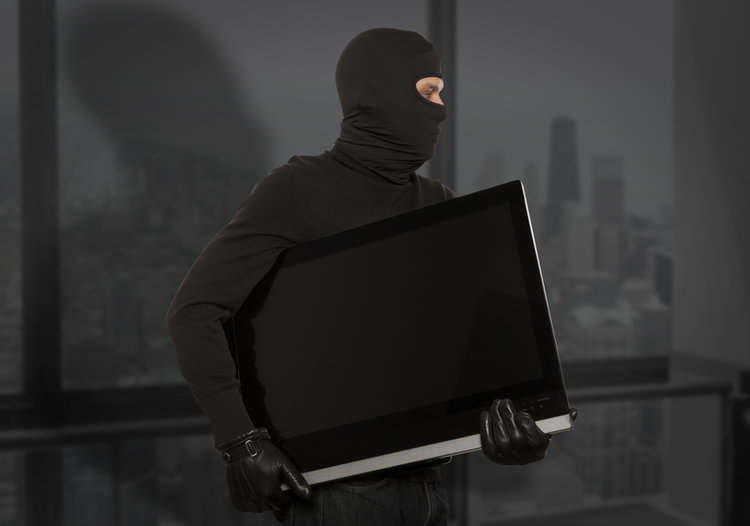 thief with black balaclava stealing a smart TV