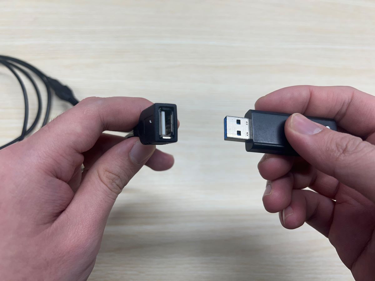 A USB is plugged into the OTG adapter cable
