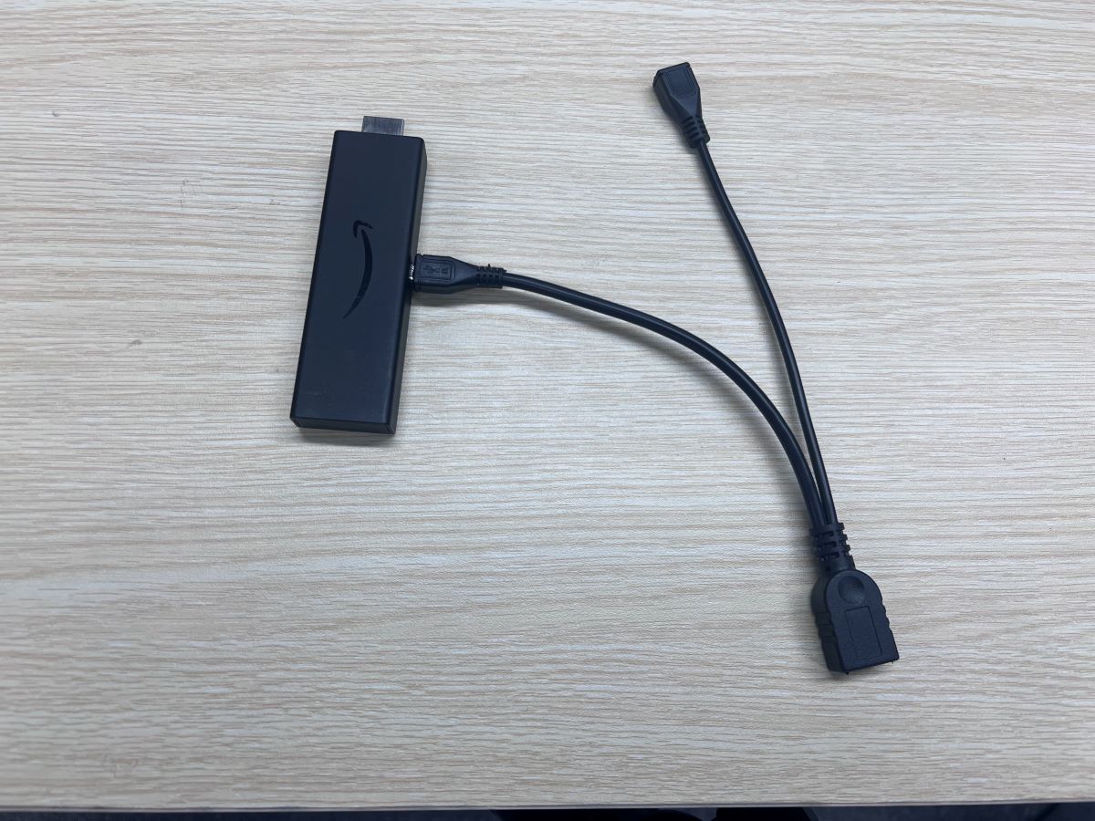 The Fire TV Stick is plugged to the OTG adapter cable