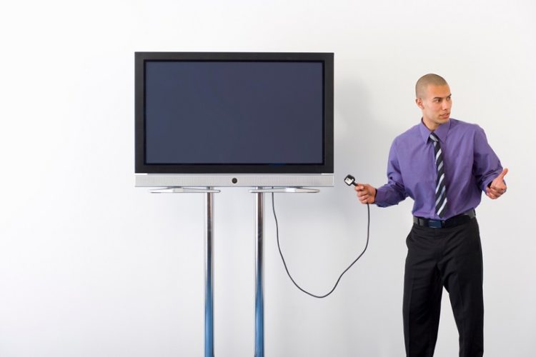 a man holding TV power cable