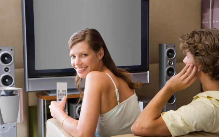 couple watching tv with the surround sound system