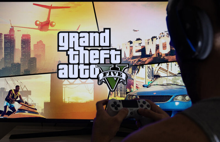 man playing Grand Theft Auto with game controller