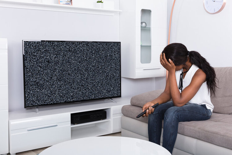 a woman is sad about her TV having no signal reception