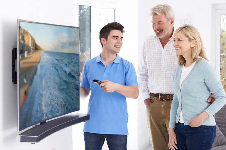 man demonstrating new television mature couple