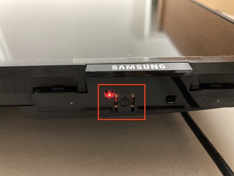 the control button on the bottom of the Samsung TV
