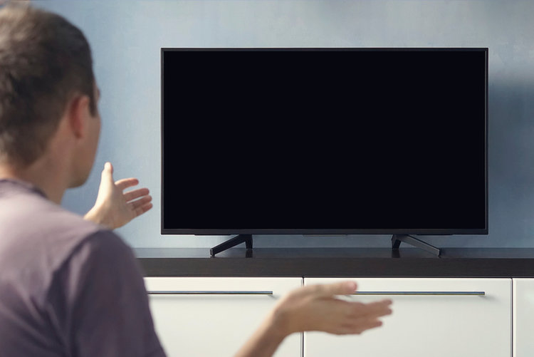 young guy discontented about his TV being dark