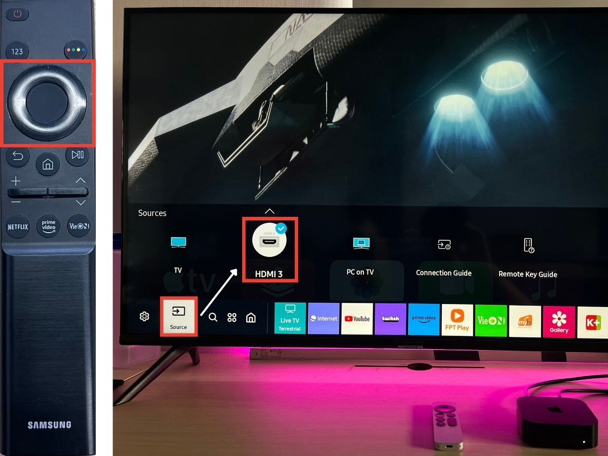 A Samsung TV with the remote is using the directional button to control the source input