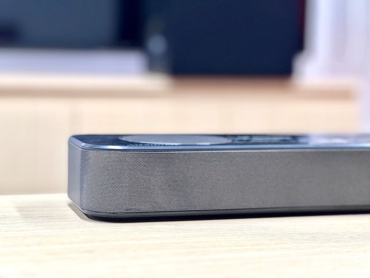 A part of a soundbar with blurred surroundings