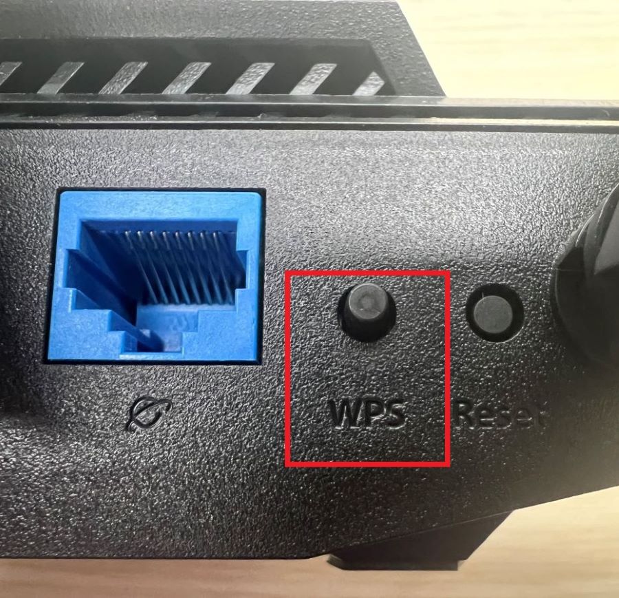 The WPS button at the back of the Asus router
