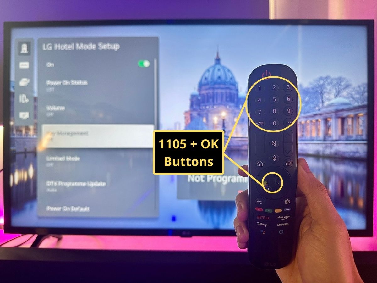 a hand holding an lg tv remote before an lg tv screen showing the hotel mode setup