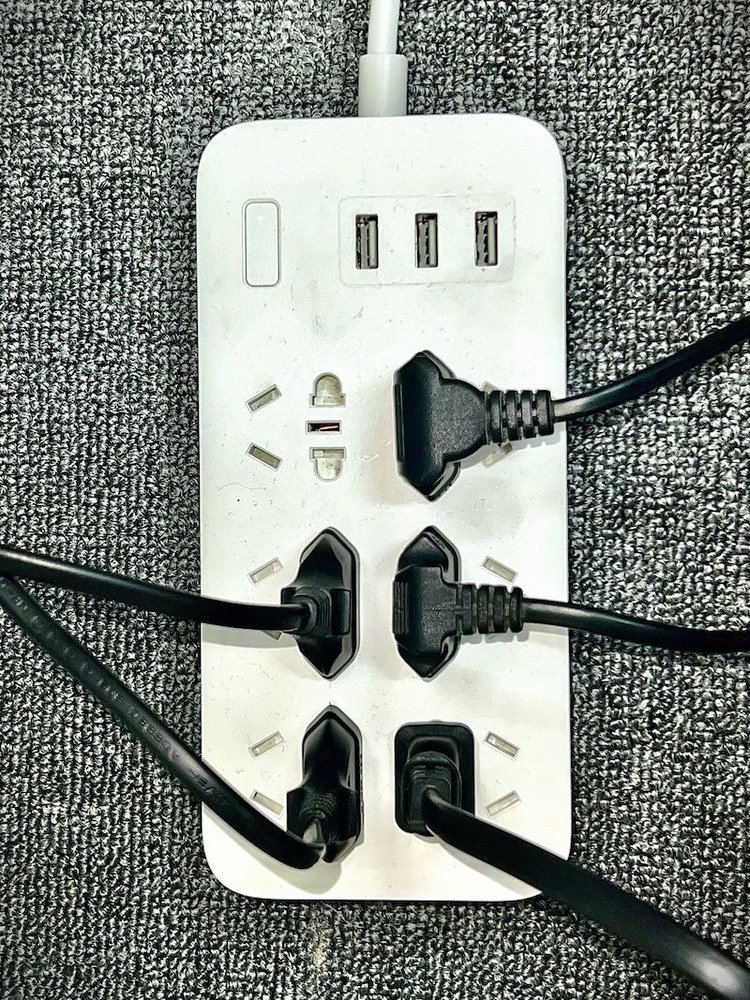 a white power strip on a floor