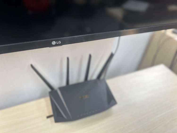 an LG smart TV with a Wi-Fi router on a table