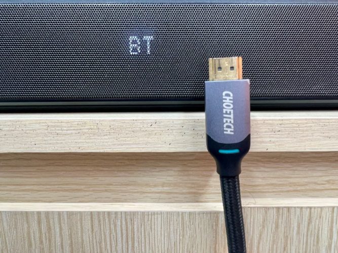 soundbar display showing BT (bluetooth) with an HDMI connector and a part of the cable beside