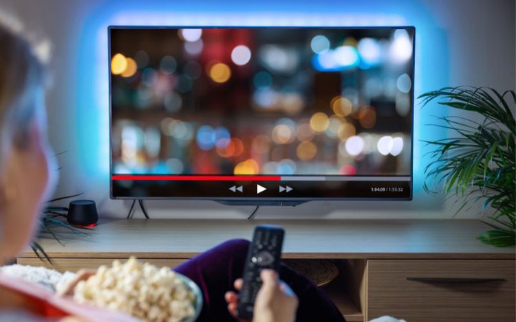 woman is watching tv with a blurry screen