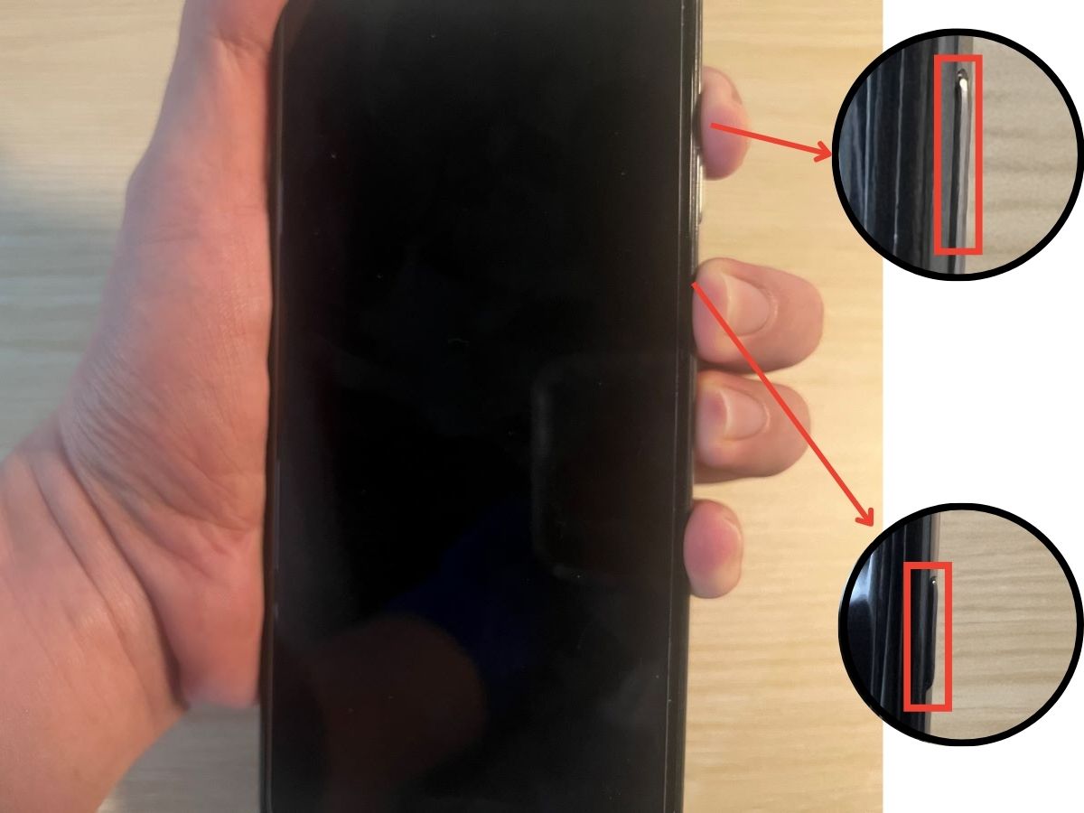 A hand is pressed simultaneously the power and volume buttons on a Samsung phone