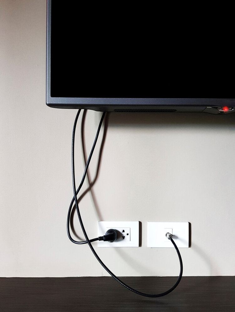 a TV with red LED light mounted on the wall