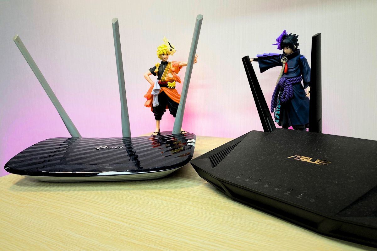a cheap TP Link and an asus router on a table