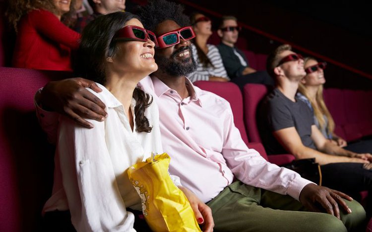 couple wearing 3D glasses in the cinema