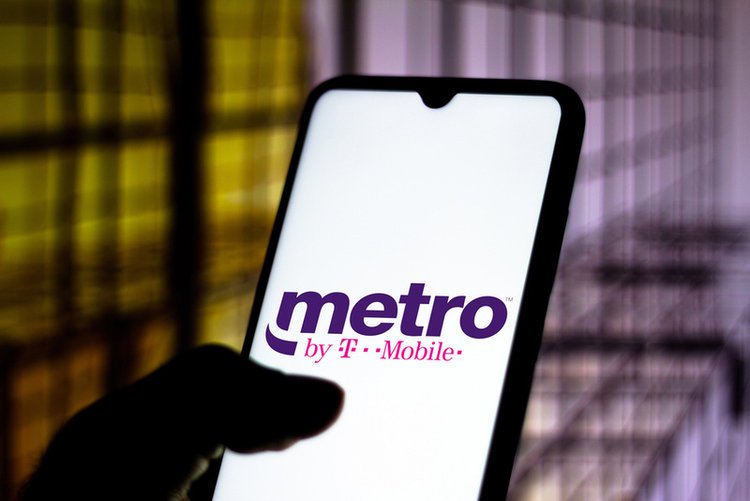 hand holding a phone with logo Metro by T-mobile
