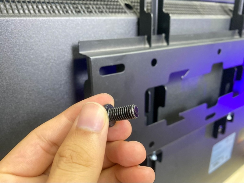 holding a Samsung TV VESA mount screw