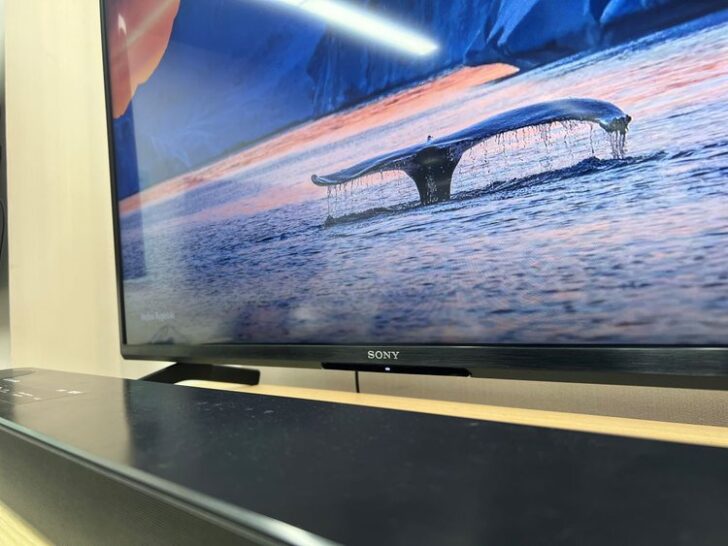sony tv with a blue background and an lg soundbar in front of it