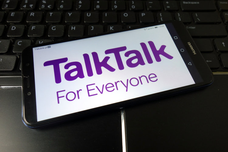 talktalk for everyone text is shown on a tablet laying on a laptop