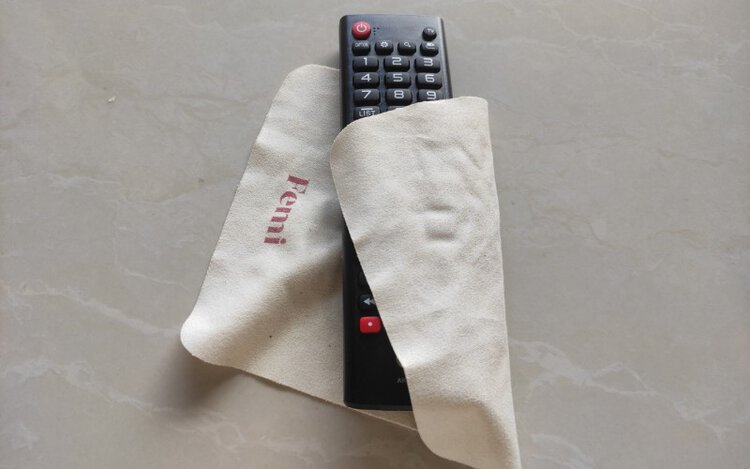 use a cloth to dry a TV remote