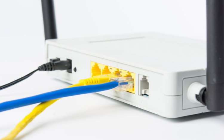 Ethernet cables are connected to a wifi router