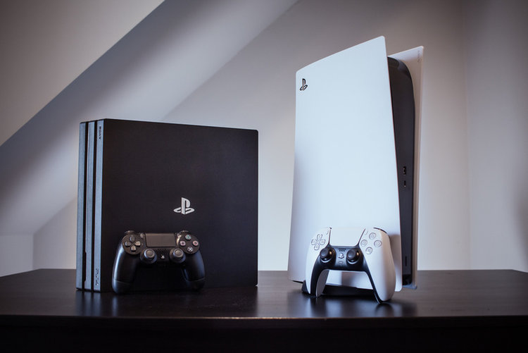 PlayStation 4 and PlayStation 5 on the table
