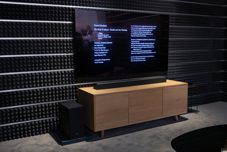 TV and soundbar on the wooden stand