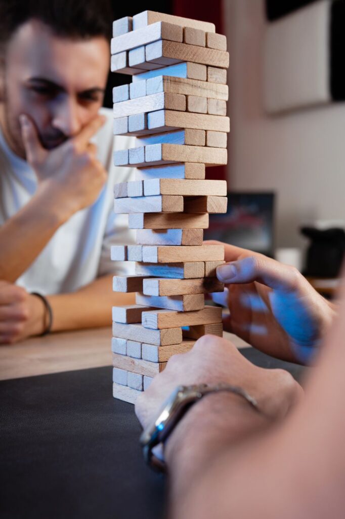 2 males are playing board game together