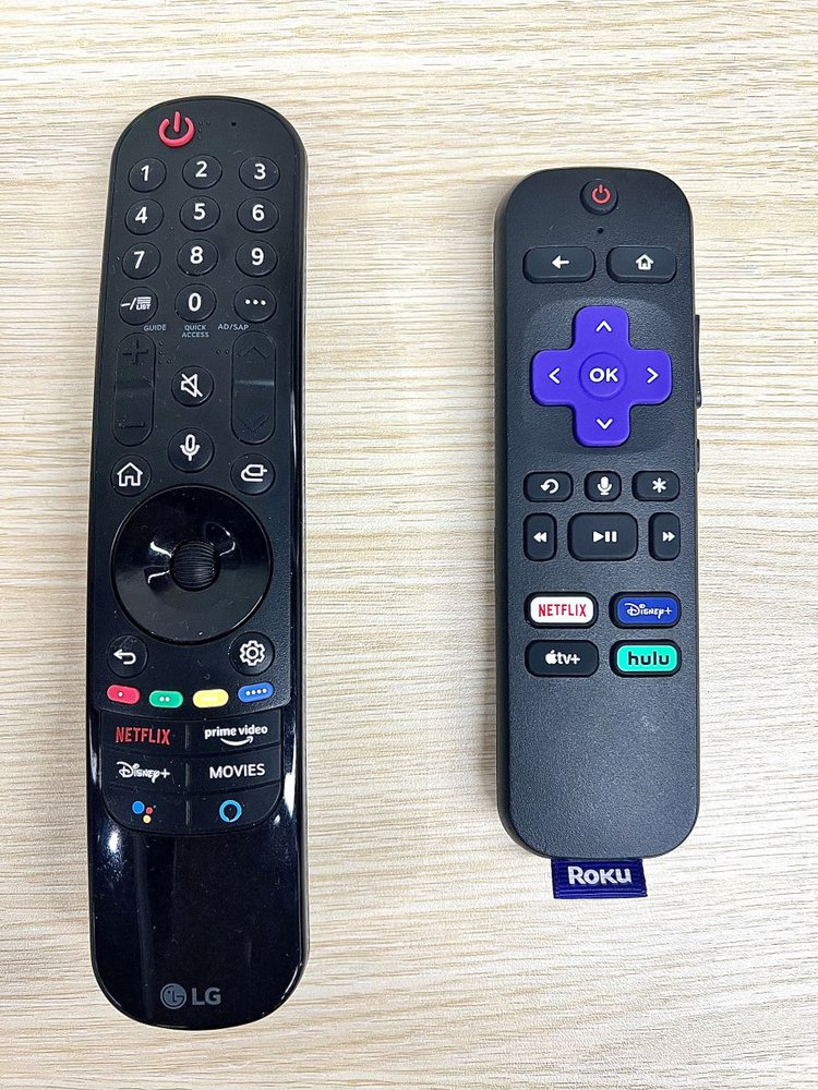an lg remote next to a roku remote