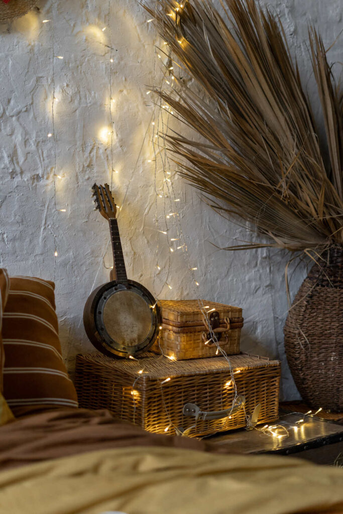 bedroom decorated with string of light blubs