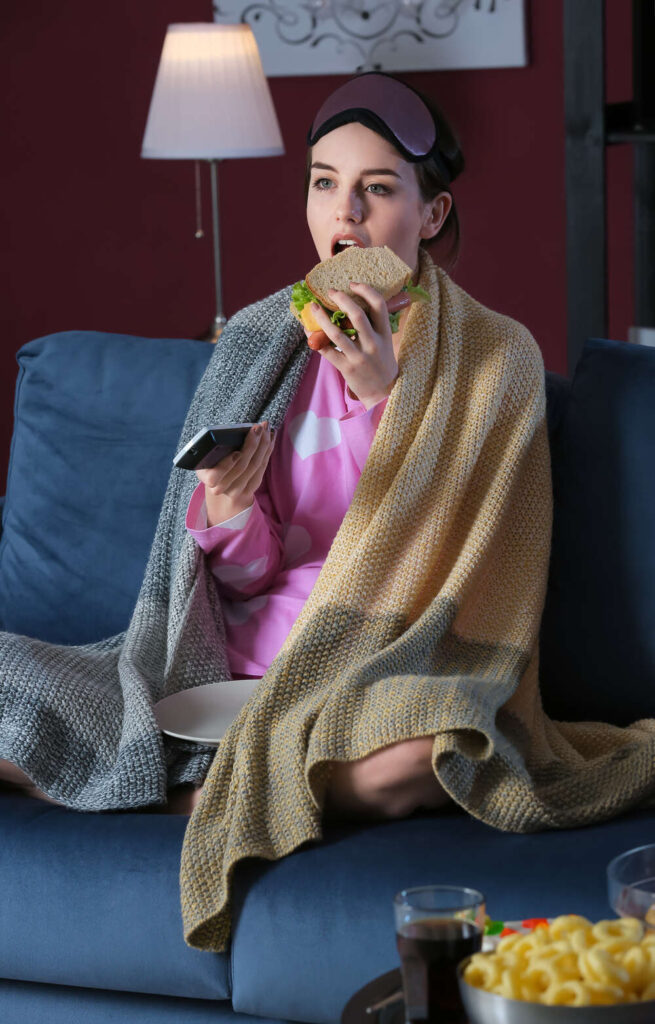 woman is eating and watching movie